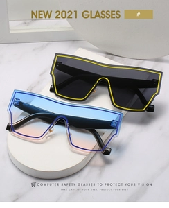 Close-up of oversized shield sunglasses with gradient lenses and modern geometric styling