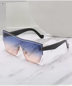 Detail of oversized sunglasses with blue to orange gradient lenses on marble background