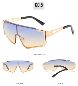 Detail of shield sunglasses with gradient lenses and gold geometric openwork temples