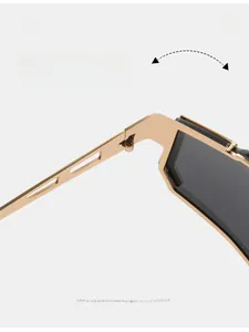 Macro detail of durable golden metal hinge and high-quality dark lens on punk sunglasses