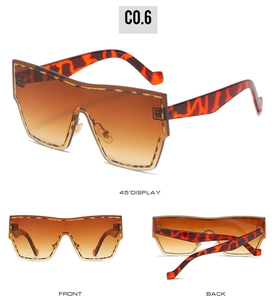 Detail view of oversized tortoiseshell shield sunglasses with brown gradient lenses