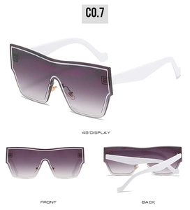 Detail view of oversized shield sunglasses featuring gradient purple lenses and white frames