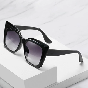 Oversized cat-eye sunglasses with glossy black frames and gradient purple resin lenses