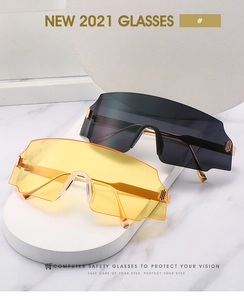 Detail showing oversized computer safety glasses with blue light protection and gold hinges