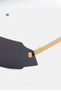 Detail of grey lenses and gold metal multi-line temples on lightweight cycling sunglasses