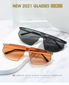 Detail of oversized flat top sunglasses with metal accents on minimalist white blocks