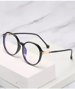 Detail of retro round TR90 frame with gold metal temples and purple anti-blue light lens