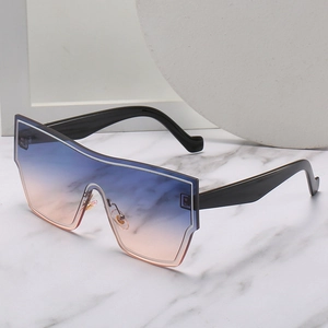 Oversized wrap-around sunglasses with blue-to-orange gradient lenses and black frames