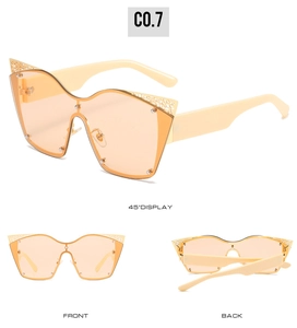 Detailed views of oversized cat-eye sunglasses with gold lace metal trim and peach lenses