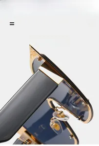 Detail view of the lightweight and flexible golden metal hinge on large cat-eye sunglasses