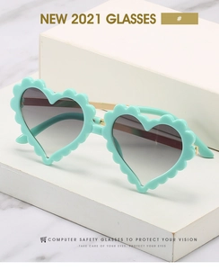 Detail of mint green scallop edge heart sunglasses with golden metal temples and grey lenses