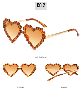 Three views of heart-shaped leopard print kids sunglasses with gold metal temples
