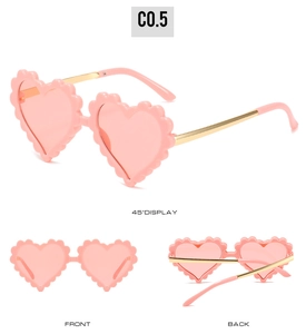 Detailed views of pink heart-shaped kids sunglasses with scalloped edges and gold temples