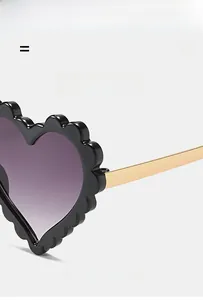 Detail showing wavy textured heart frame and purple gradient lenses on sunglasses