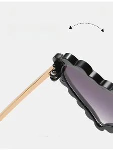 Close-up of durable golden metal hinge on black flower shape kids sunglasses