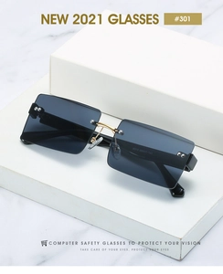 Detail of square gradient blue sunglasses with gold rivets on a white marble display