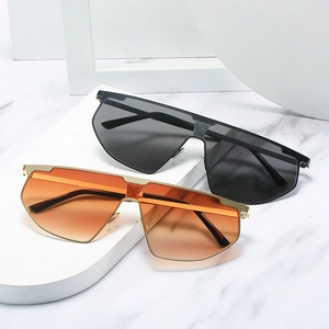 Modern oversized flat top sunglasses with metal frame in black and orange gradient lenses