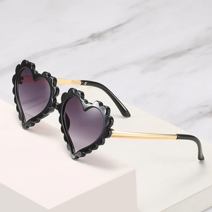 Fashionable heart-shaped kids sunglasses with black wave frame and purple gradient lenses