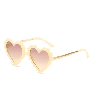 Fashionable heart-shaped kids sunglasses with cream scalloped frames and gold metal temples