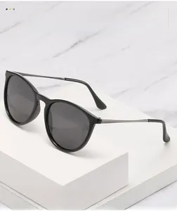 Detail of polarized sunglasses with metal temples on a white geometric display stand