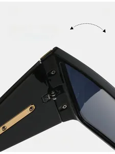Macro shot of durable black frame sunglasses with golden metal hinge detail