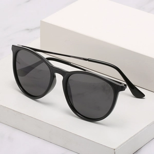 Classic polarized black round sunglasses with sleek frame on a minimalist background