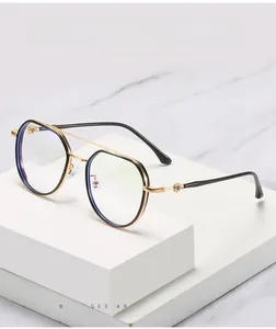 Detail of floral cross embossed hinge on geometric black and gold anti-blue light glasses