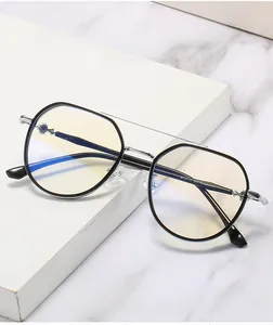 Detail of blue light blocking glasses with black polygonal frame and metallic cross decor