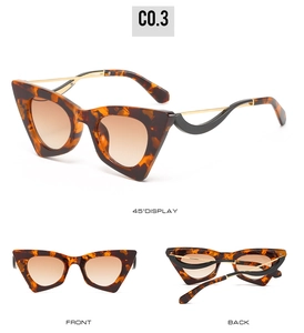Vue détaillée des lunettes œil de chat, monture écaille et branches ondulées dorées