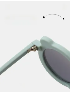 Detailed macro view of mint green bear sunglasses showing durable metal hinge construction