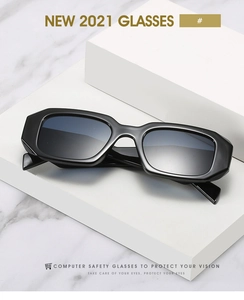 Detail of 2021 rectangular oversized sunglasses on a minimalist white platform