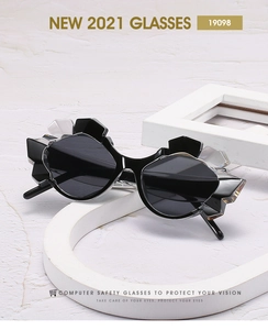 Detail showing avant-garde asymmetric geometric sunglasses with black and white frame