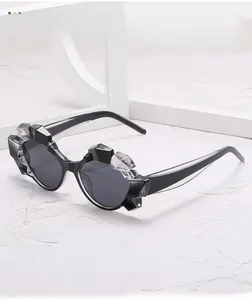Detailed close-up of geometric polygon sunglasses with black textured rock-cut frames