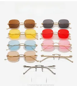 Close-up of rimless retro sunglasses in nine colors with gold metal temples and bridge