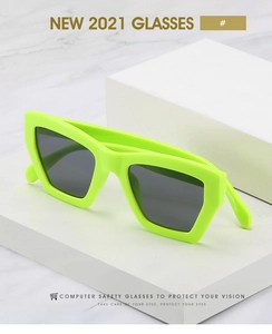 Close-up of stylish neon green square sunglasses on a white minimalist background