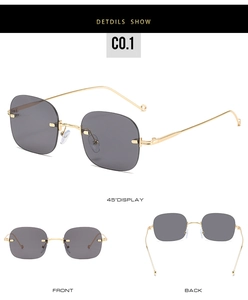 Detail view of gold metal temples and dark grey lenses of rimless square sunglasses