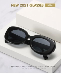 Detail of vintage oval sunglasses M304 on geometric blocks with dark grey lenses