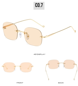 Detail view of gold metal hinges and orange lenses of rimless square sunglasses