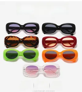 Collection of colorful vintage oval sunglasses in black, red, and neon green shades