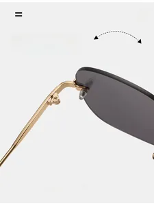 Close-up of durable golden metal hinges and smokey grey lenses on rimless sunglasses