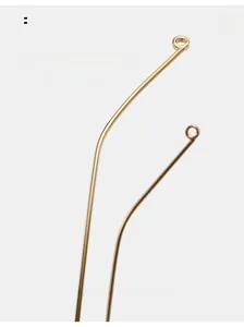 Detail of curved gold metal eyewear temples with smooth polished finish and ergonomic design
