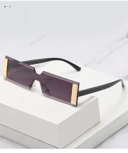 Detail of rimless rectangle sunglasses with purple lenses and gold metal hardware