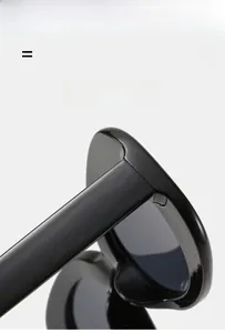 Detail of high-gloss black sunglasses showing reinforced hinge and wide temple structure