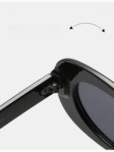 Detailed close-up of high-quality metal hinges on black oval minimalist sunglasses