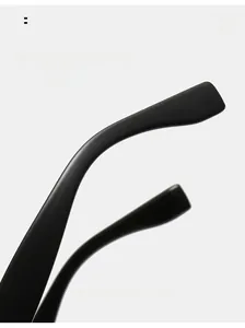 Detail of ergonomic curved temple design on matte black sunglasses for comfortable wear