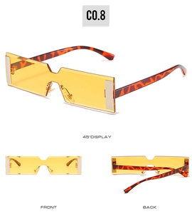 Detail view of rectangular sunglasses with yellow lenses and tortoiseshell frame design