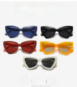 Detailed flat lay of five colored cat-eye sunglasses including blue and orange frames
