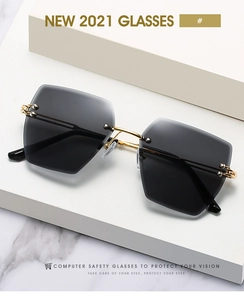 Detail of rimless square sunglasses with gradient grey lenses and golden metal temples