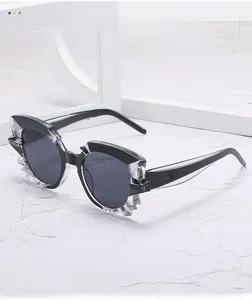 Detailed view of black cat-eye sunglasses with geometric transparent faceted frame edges