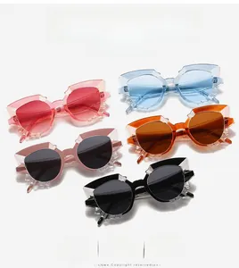 Detailed view of geometric cat-eye sunglasses in five transparent colors with faceted edges